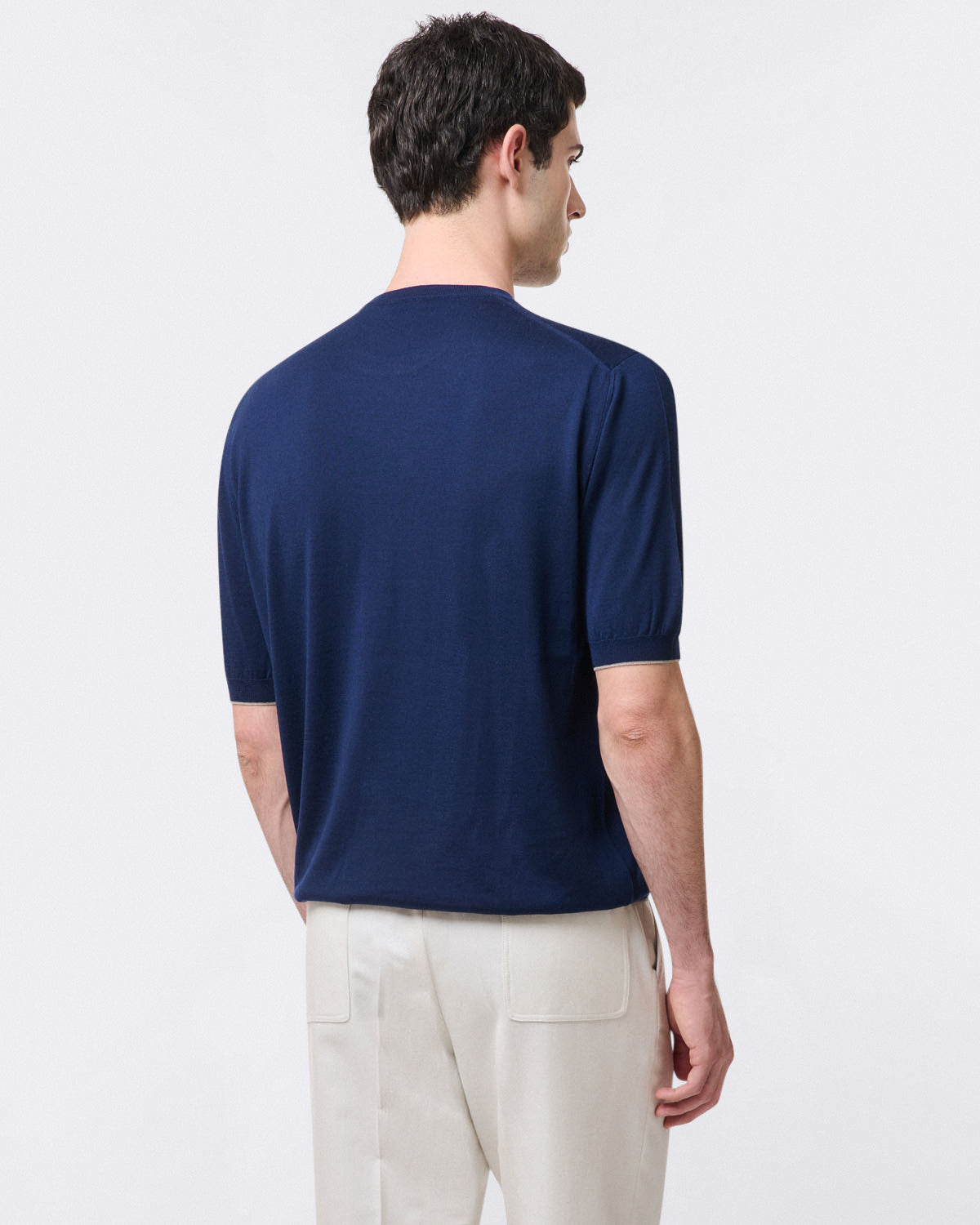 Pure virgin wool crew neck sweater with ribbed trim. Short sleeves