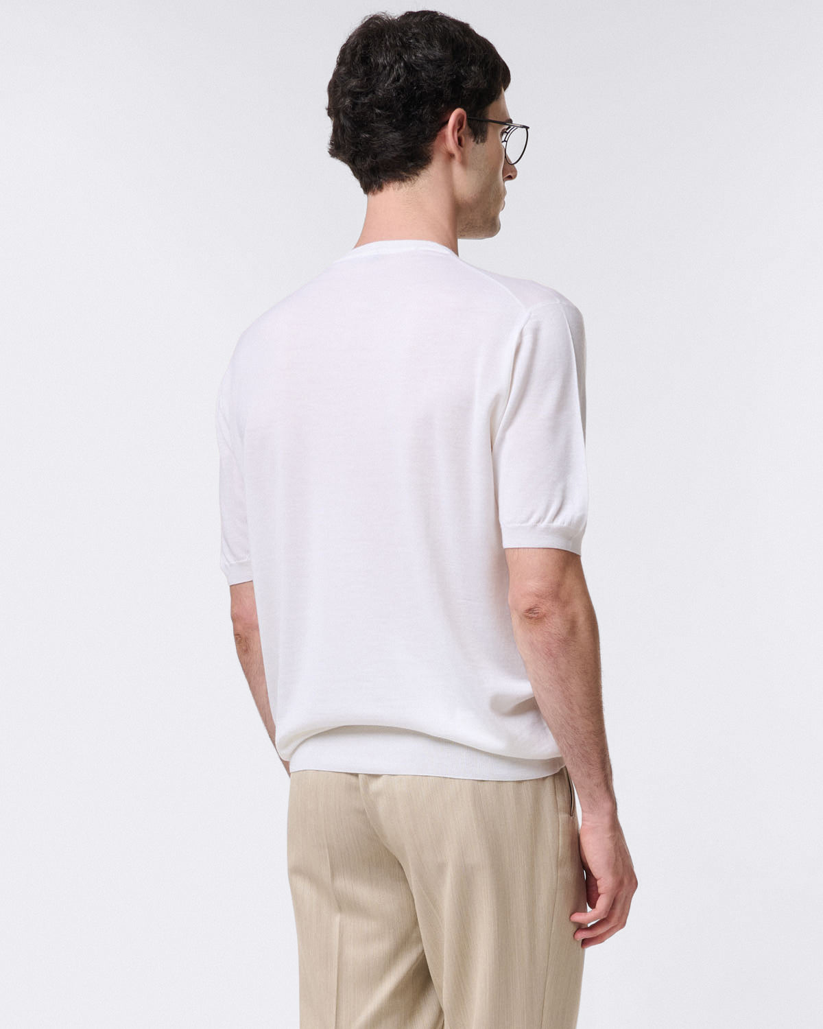 Pure virgin wool crew neck sweater with ribbed trim. Short sleeves