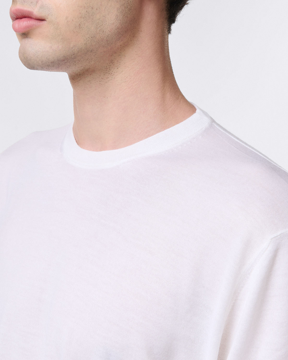 Pure virgin wool crew neck sweater with ribbed trim. Short sleeves
