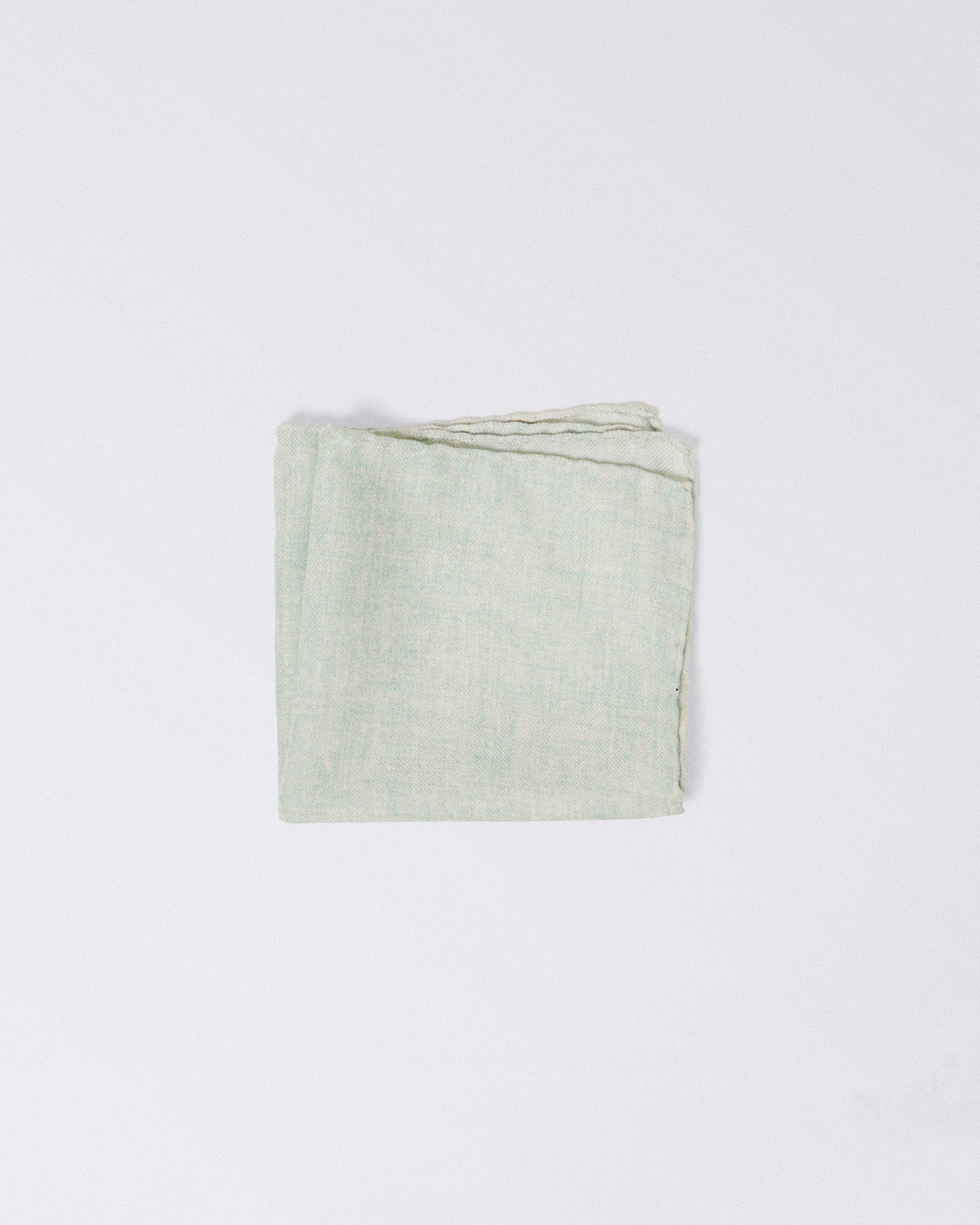 Hand finished single colour wool pocket square. Light green