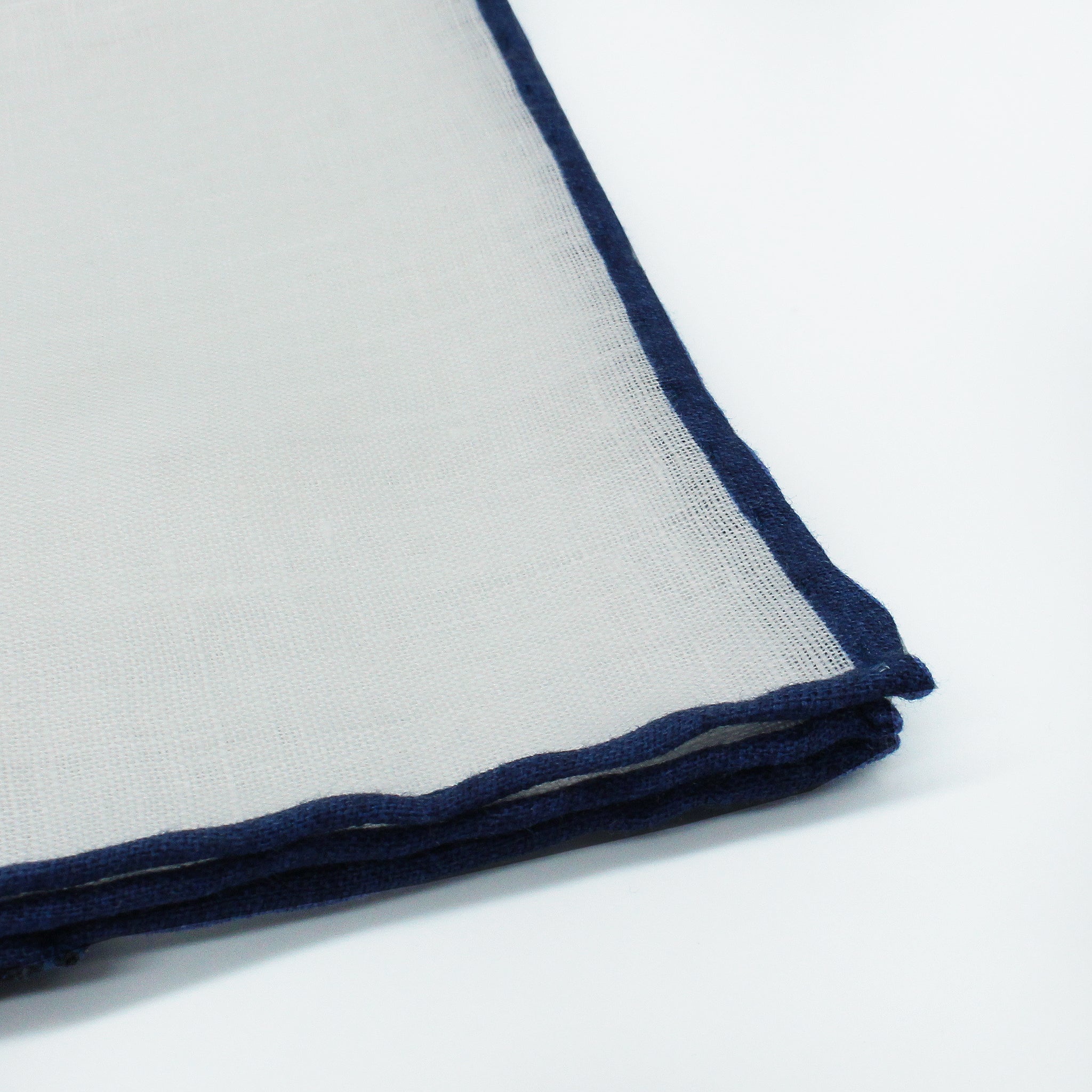 Linen pocket square with white background and blu border