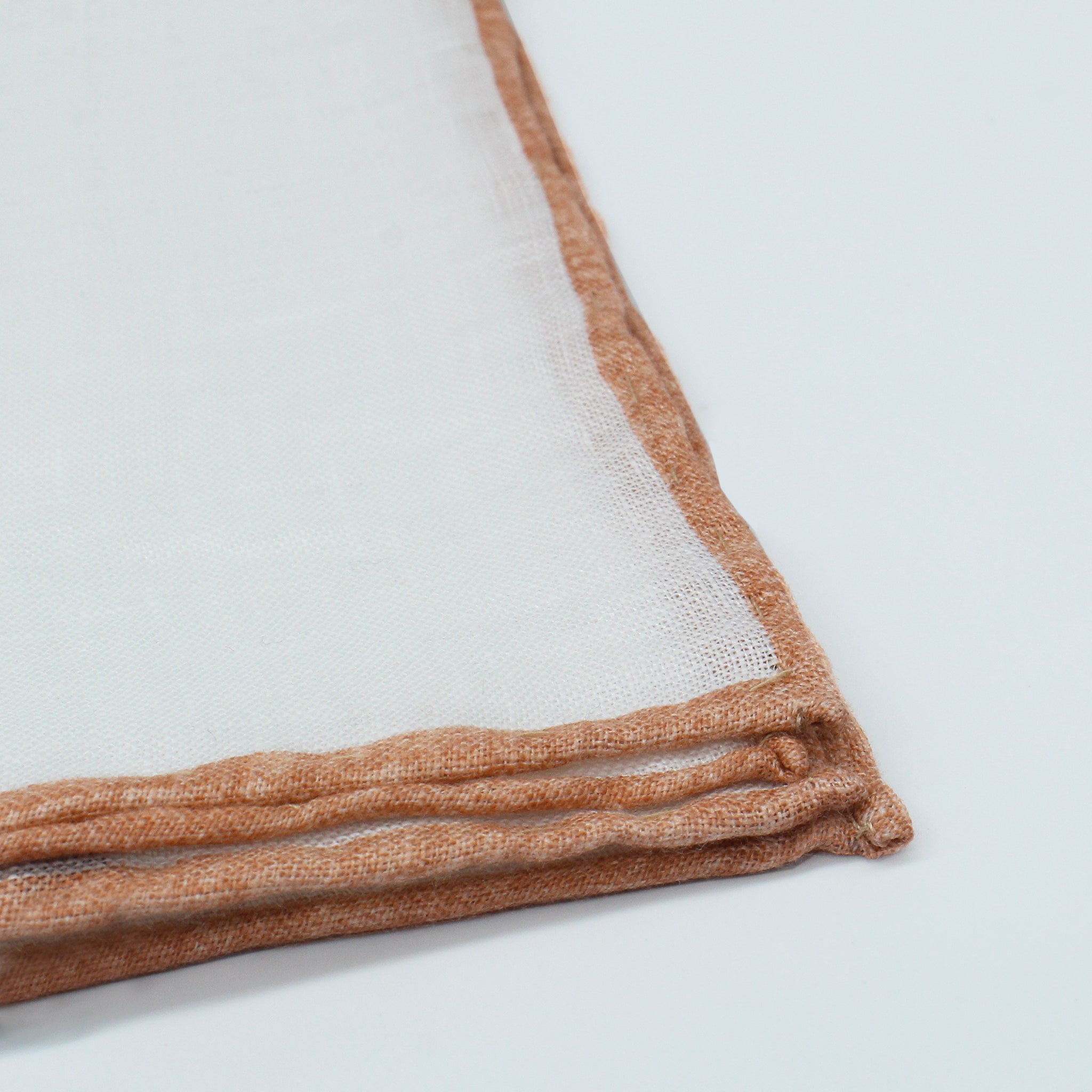 Linen pocket square with white background and Peach Fuzz border